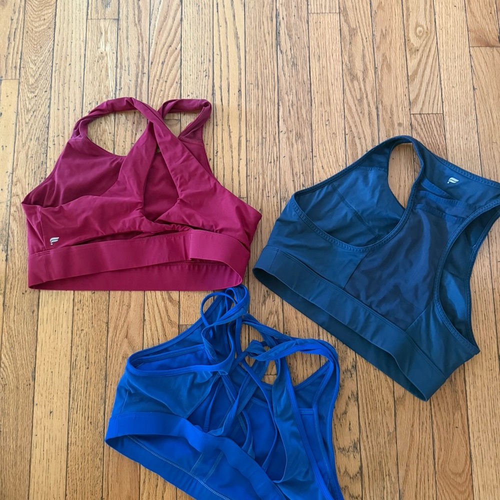 Three Strappy Sports Bras in Berry, Teal, and Cobalt